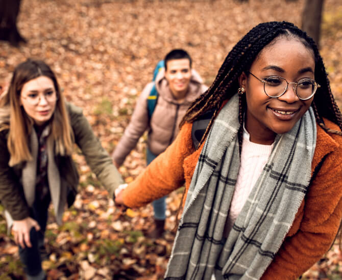 Psychiatric patient hikes in the woods with friends.