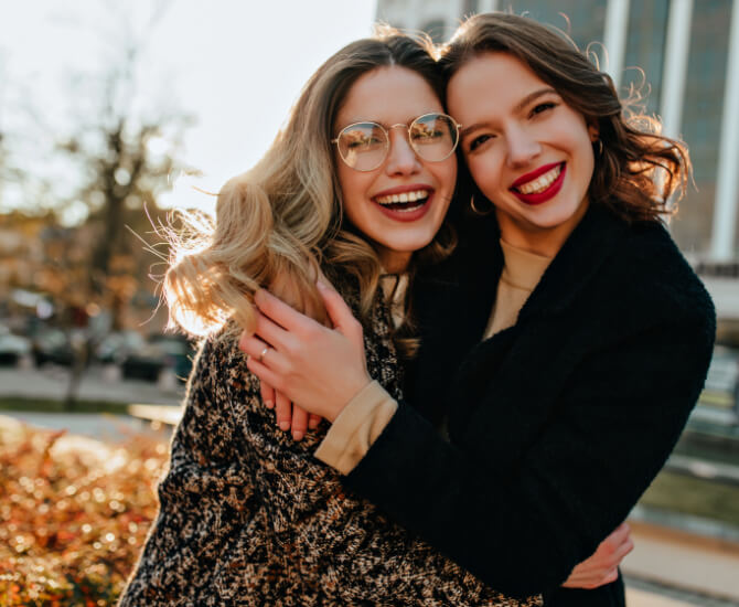 Happy psychiatric patient embraces friend.